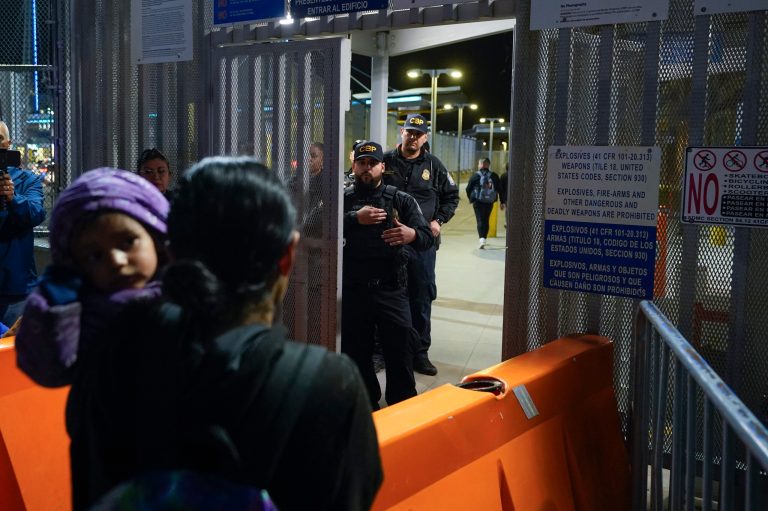 Paula, foreground, of Guatemala, holds her daughter as she asks U.S. Customs and Border Protection officials about new asylum rules at the San Ysidro Port of Entry on May 11, 2023, in Tijuana, Mexico.