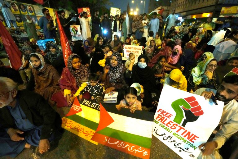 Supporters of Shehri Awami Mahaz and national trade union federation, candlelight protest against Israeli airstrikes on Gaza, and to show solidarity with Palestinian people, in Karachi, Pakistan, Sunday, Dec. 31, 2023. 