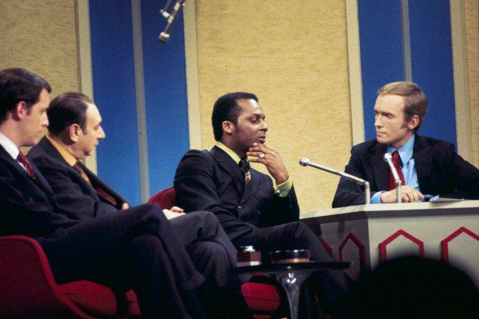 Curt Flood of the St. Louis Cardinals, center, is seen on the "Dick Cavett Show," with sportscaster Howard Cosell, second from left, and Dick Cavett, in New York, Jan. 20, 1970.