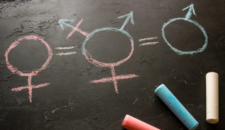 Chalk board drawing of the female, intersex, and male symbols.