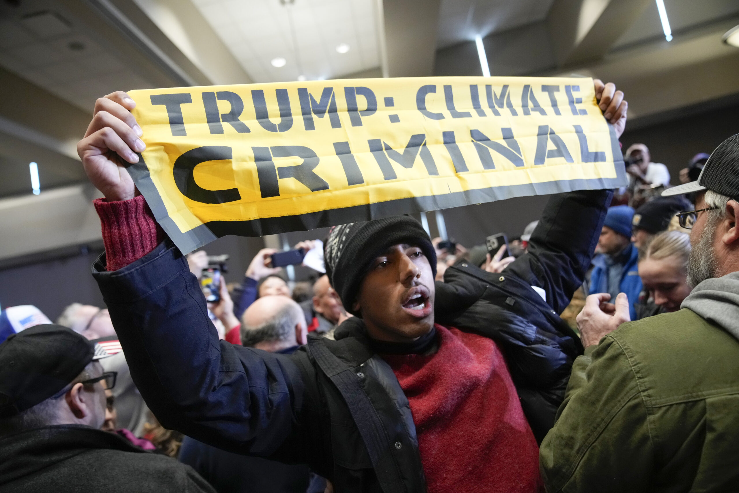 Trump’s final rally before Iowa caucuses interrupted by climate protesters