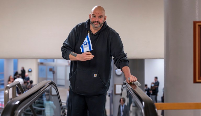Sen. John Fetterman (D-PA) holds a small Israel flag at the Capitol in Washington, Thursday, Jan. 25, 2024. (AP Photo/J. Scott Applewhite)