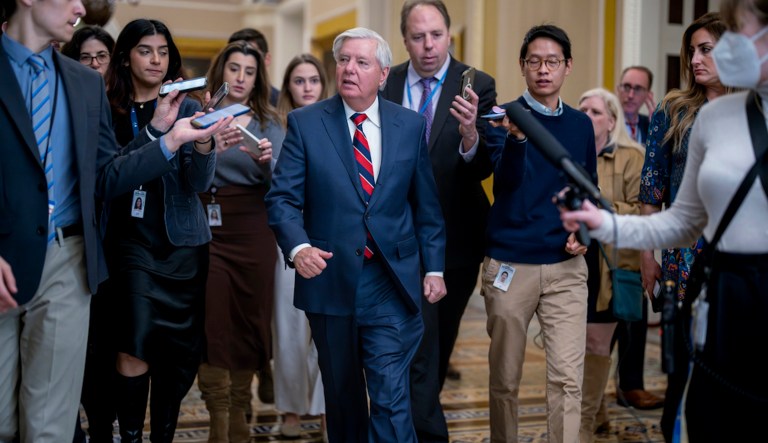 Sen. Lindsey Graham (R-SC) walks past reporters seeking comment to the Senate chamber during a test vote at the Capitol in Washington, Wednesday, Feb. 7, 2024. (AP Photo/J. Scott Applewhite)