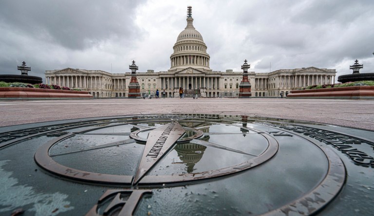 The U.S. Capitol Dome is reflected in a rain puddle on the compass star on the east side of the building, Sunday, Sept. 24, 2023. (AP Photo/J. David Ake)