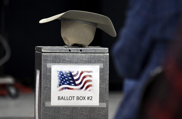 A cowboy hat rests upside down on a ballot box in Hugo, Colo., before a panel of Republicans selected Greg Lopez to run in a special election to serve out the final months of U.S. Rep. Ken Buck's term.