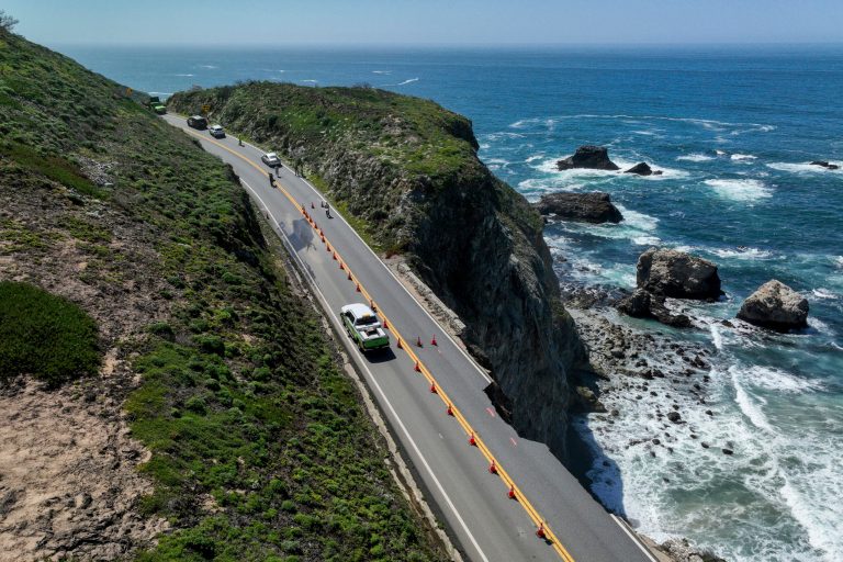 Motorists creep along one lane after part of California’s iconic Highway 1 collapses