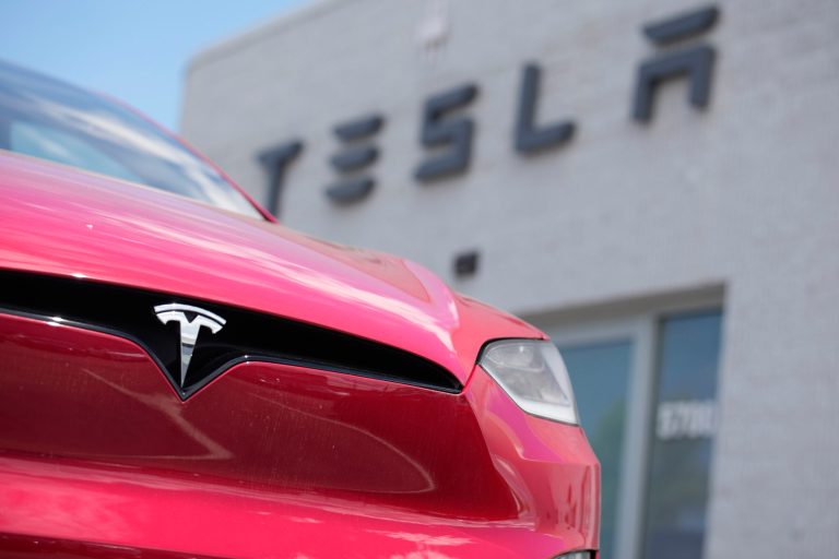 A Model X sports-utility vehicle sits outside a Tesla store in Littleton, Colorado, June 18, 2023.