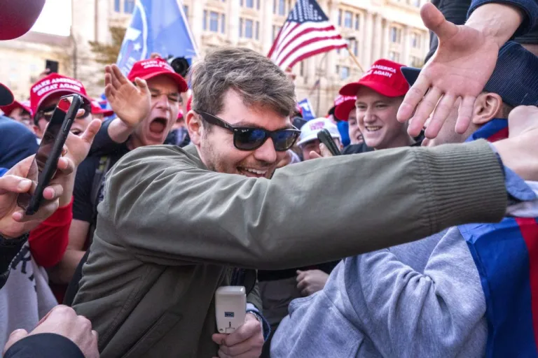 Nick Fuentes right-wing podcaster, center, greets supporters before speaking at a pro-Trump march, Nov. 14, 2020, in Washington. (AP Photo/Jacquelyn Martin, File)