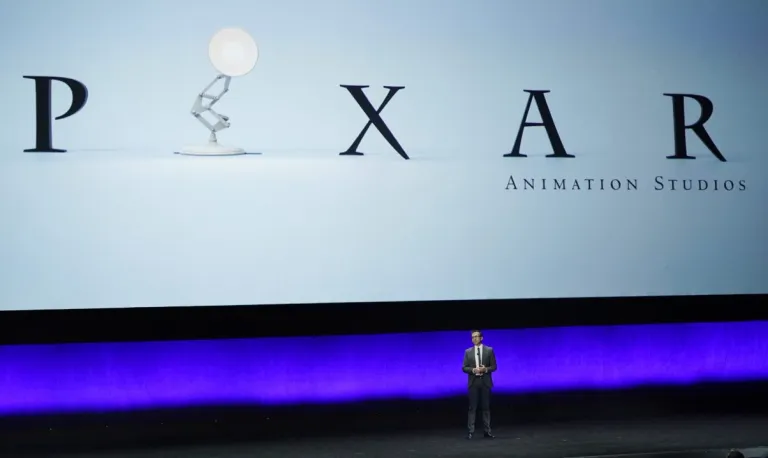 Tony Chambers, the head of theatrical distribution for Disney Entertainment, addresses the audience underneath a Pixar Animation Studios logo during the Walt Disney Studios presentation at CinemaCon 2023, the official convention of the National Association of Theatre Owners (NATO) at Caesars Palace, Wednesday, April 26, 2023, in Las Vegas. (AP Photo/Chris Pizzello)