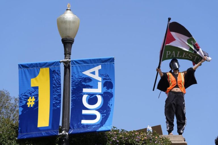 Demonstrators wave flags on the UCLA campus, after nighttime clashes between Pro-Israel and Pro-Palestinian groups, May 1, 2024, in Los Angeles. (AP Photo/Jae C. Hong, File)