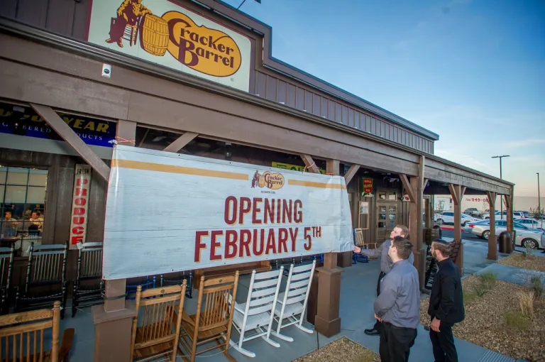 Employees hang opening sign at California Cracker Barrel Old Country Store during the Special Guest Preview on Friday, Feb. 2, 2018. Cracker Barrel will open its first California location in Victorville on Monday, Feb. 5, 2018.