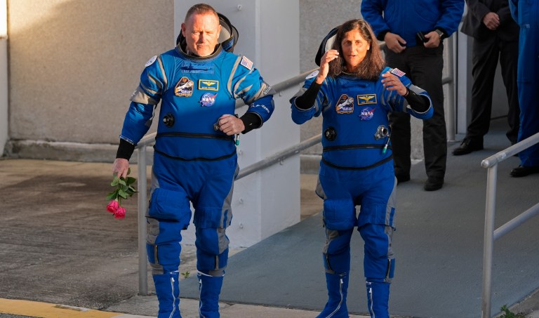 NASA astronauts Butch Wilmore, left, and Suni Williams leave the Operations and Checkout building before heading to Space Launch Complex 41 to board Boeing's Starliner capsule atop an Atlas V rocket for a mission to the International Space Station at the Cape Canaveral Space Force Station, Monday, May 6, 2024, in Cape Canaveral, Fla.