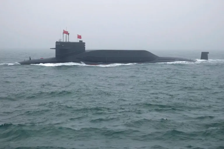 A type 094 Jin-class nuclear submarine Long March 15 of the Chinese People's Liberation Army (PLA) Navy participates in a naval parade to commemorate the 70th anniversary of the founding of China's PLA Navy in the sea near Qingdao in eastern China's Shandong province, Tuesday, April 23, 2019. (AP Photo/Mark Schiefelbein, Pool)