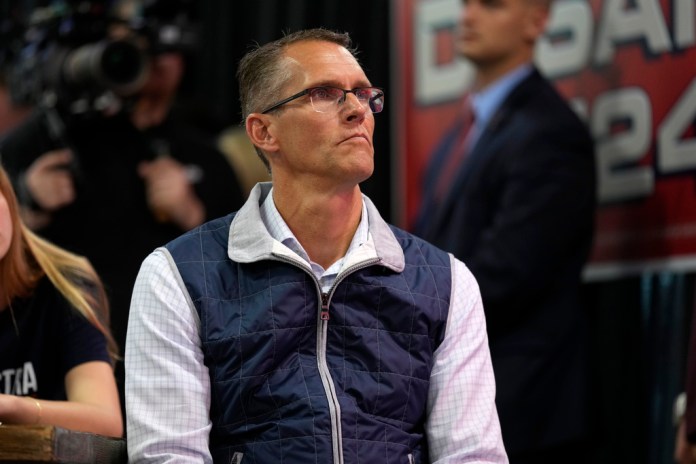 U.S. Rep. Randy Feenstra, R-Iowa, listens to Florida Gov. Ron DeSantis speak during a fundraising picnic, Saturday, May 13, 2023, in Sioux Center, Iowa. (AP Photo/Charlie Neibergall)