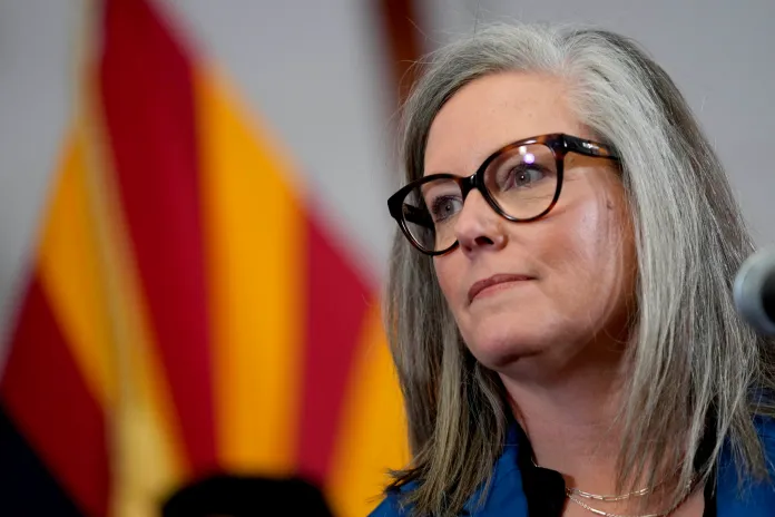 FILE - Gov. Katie Hobbs (D-AZ), speaks prior to signing the repeal of the Civil War-era near-total abortion ban, Thursday, May 2, 2024, at the Capitol in Phoenix. Arizona lawmakers approved a bipartisan budget deal Saturday, June 15, that erases a $1.4 billion shortfall by curbing spending on higher education, trimming funding for state agencies, and raiding a host of special funds. (AP Photo/Matt York, File)
