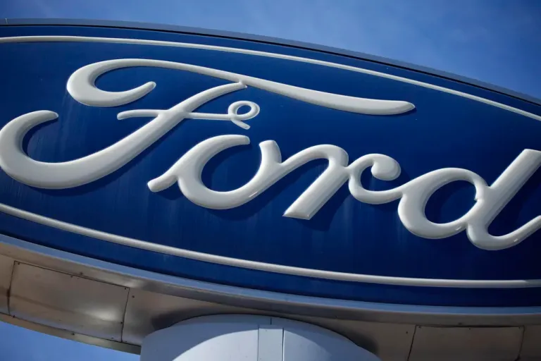 This Oct. 24, 2021 file photo shows a Ford company logo on a sign at a Ford dealership in southeast Denver. Ford is recalling more than 550,000 pickup trucks in the U.S., Tuesday, June 25, 2024, because the transmissions can unexpectedly downshift to first gear no matter how fast the trucks are going. The recall covers certain F-150 pickups from the 2014 model year. Ford's F-Series pickups are the top-selling vehicles in the U.S.