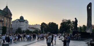The Royal Brass Band, a group of young musicians, performs for an audience of passersby at near the Taras Shevchenko Monument in Lviv