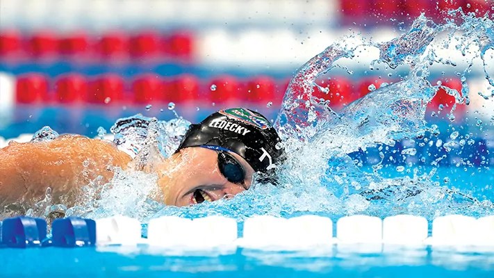 U.S. swimmer wins gold and sets Olympic record