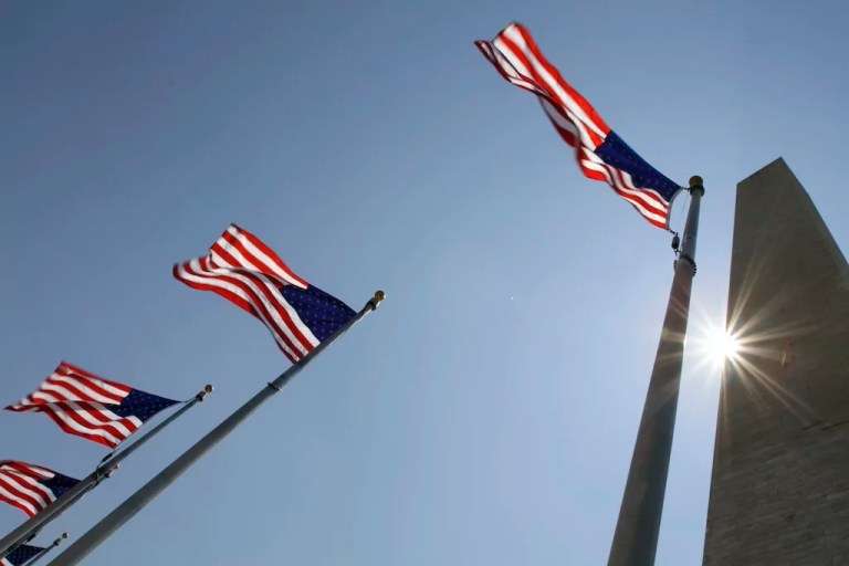 Flags wave at the Washington Monument on the National Mall in Washington, Tuesday, July 12, 2011, as temperatures climbed into the upper 90s in the Washington area.