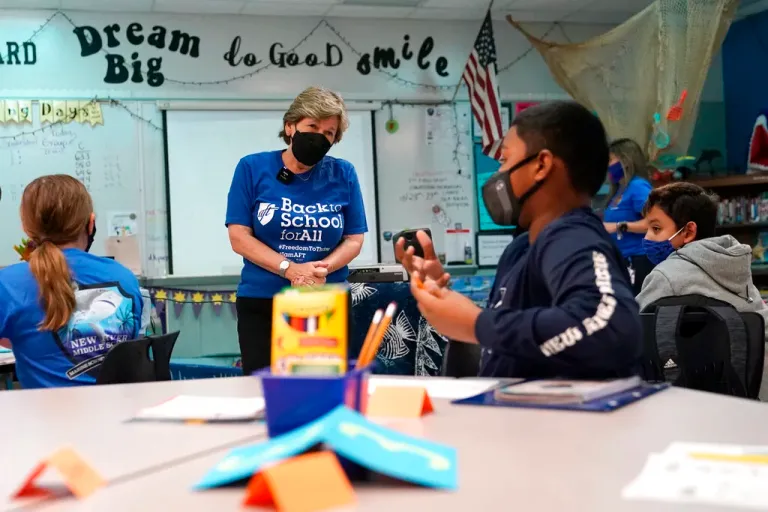 American Federation of Teachers President Randi Weingarten, left, speaks with students at the New River Middle School, Thursday, Sept. 2, 2021, in Fort Lauderdale, Fla. Weingarten is on a nationwide tour of schools to stress the importance of safely returning to five-day-a-week in person learning. Broward County is one of numerous school districts in Florida with a mask mandate for students. (AP Photo/Lynne Sladky)