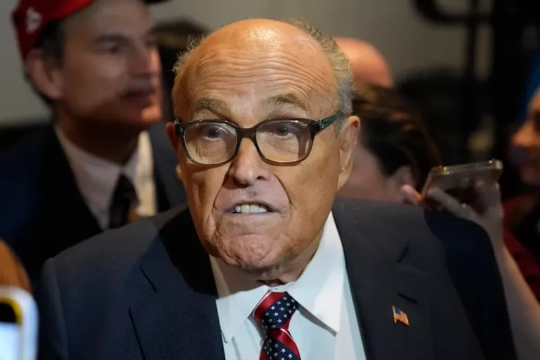 Former New York City Mayor Rudy Giuliani speaks to reporters after former President Donald Trump, Republican presidential candidate, spoke at a primary election night party in Nashua, New Hampshire, Tuesday, Jan. 23, 2024. Giuliani will be allowed to remain in his Florida condo for now after a New York bankruptcy judge declined Thursday, April 4, 2024, to rule on a motion filed by his creditors that would’ve forced him to sell the Palm Beach estate. Giuliani declared bankruptcy in December after he was ordered to pay $148 million to two former Georgia election workers for spreading lies about their role in the 2020 election.
