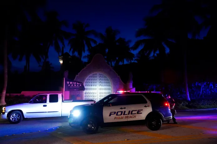 A supporter of former President Donald Trump drives past his Mar-a-Lago estate as the FBI was conducting a search of his Mar-a-Lago estate.