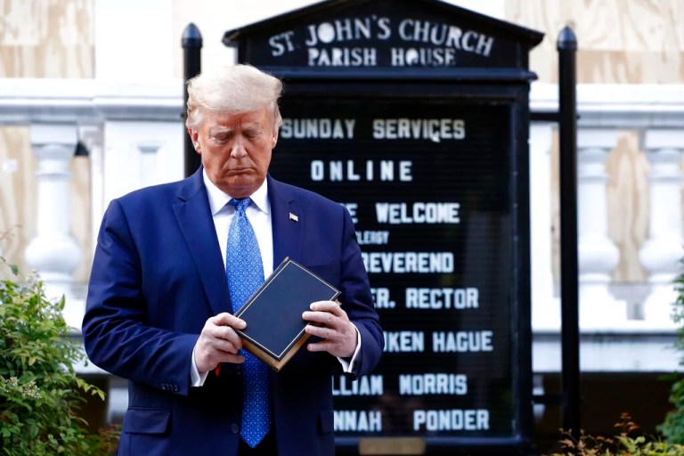 In this June 1, 2020, file photo, President Donald Trump holds a Bible as he visits outside St. John's Church across Lafayette Park from the White House in Washington.