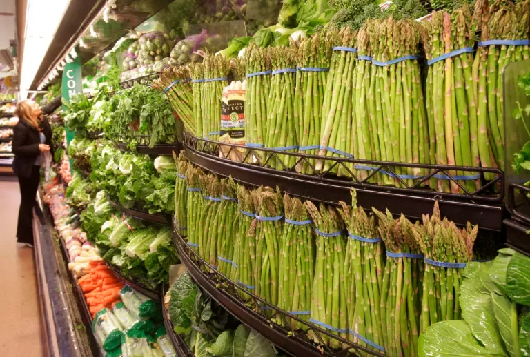 A customer looks at fresh vegetables at a Kroger Co. supermarket in Cincinnati.