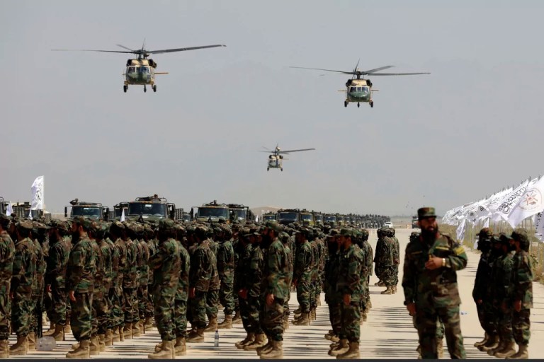 UH-60 Black Hawk helicopters fly during a military parade to mark the third anniversary of the withdrawal of U.S.-led troops from Afghanistan in Bagram Air Base in the Parwan Province of Afghanistan, Wednesday, Aug. 14, 2024.