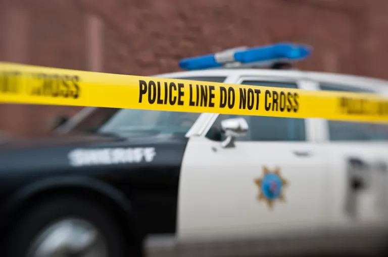 Sheriff's police car with yellow barrier tape saying, 