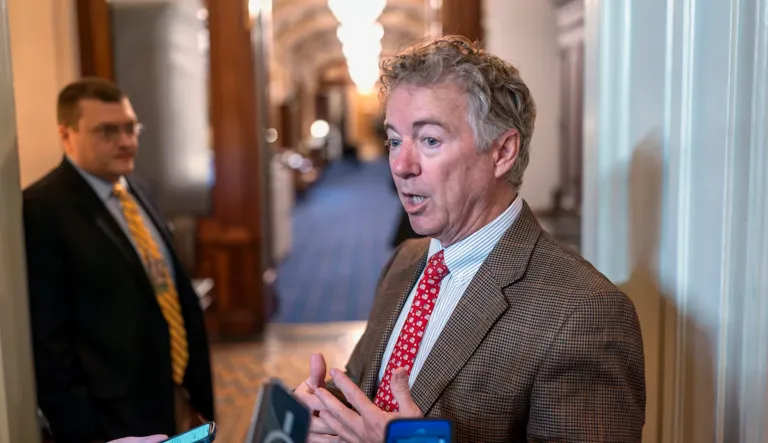 Sen. Rand Paul (R-KY) pauses to speak to reporters outside the chamber as the Senate prepares a procedural vote on an emergency spending package that would provide military aid to Ukraine and Israel, replenish U.S. weapons systems, and provide food, water and other humanitarian aid to civilians in Gaza, at the Capitol in Washington, Sunday, Feb. 11, 2024.