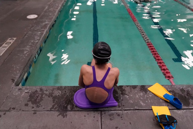 A 12-year-old transgender swimmer is seen waiting by a pool, Feb. 22, 2021, in Utah. She and her family spoke to The Associated Press on the condition of anonymity. Transgender teenagers challenging a Utah law banning trans girls from playing on girls' sports teams can keep portions of their mental health records confidential after a state judge ruled Thursday, Dec. 7, 2023, that some details were irrelevant to the case.