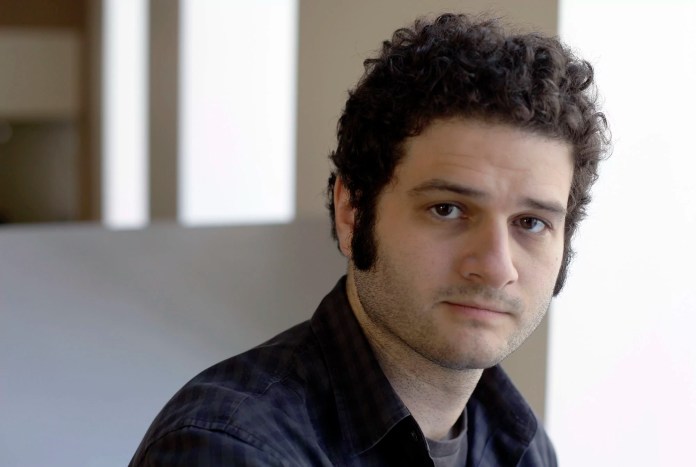 Dustin Moskovitz, a Facebook co-founder, poses outside of his office in San Francisco. Moskovitz says he is giving $20 million to help defeat Donald Trump, calling the Republican presidential candidate divisive and dangerous and his appeals to Americans who feel left behind "quite possibly a deliberate con."  (AP Photo/Eric Risberg)