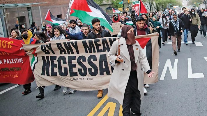 Protesters march outside Columbia University in New York City, April 18, 2024.