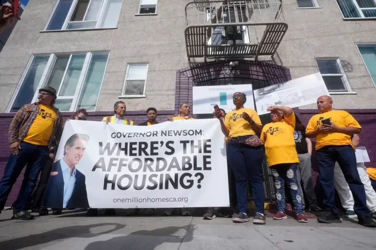 Merika Goolsby, of Alliance of Californians for Community Empowerment (AACE) board, middle right, speaks during a news conference and rally