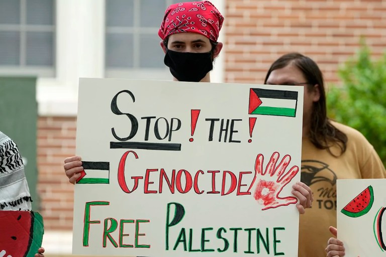 A protester holds his pro-Palestinian sign protesting the Israel-Hamas war in Gaza, during an hourlong silent protest on the school's campus, Tuesday, May 7, 2024, in Hattiesburg, Mississippi.