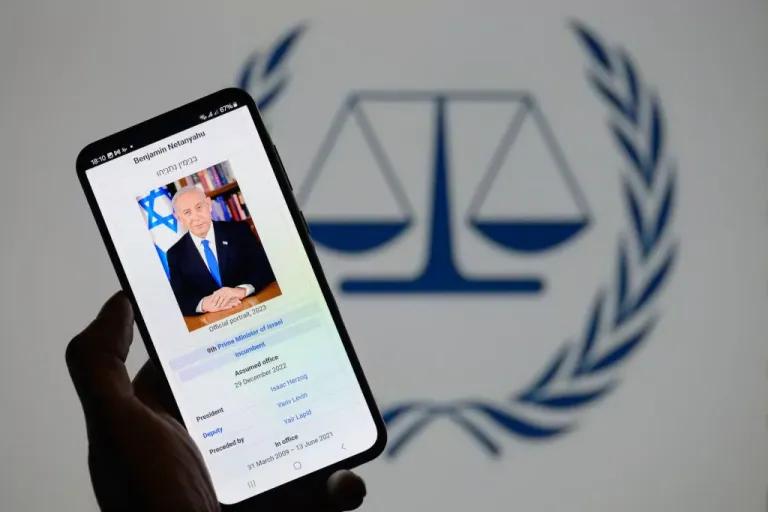 Benjamin Netanyahu appears on a smartphone with the International Criminal Court logo visible in the background in this photo illustration in Brussels, Belgium, on November 25, 2024. (Photo by Jonathan Raa/NurPhoto via Getty Images)