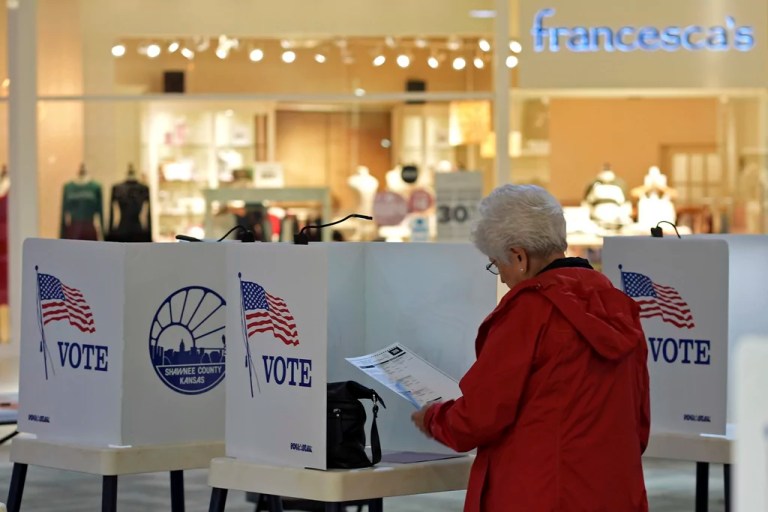 Delores Engel looks over her ballot while voting at the West Ridge Mall Tuesday, Nov. 5, 2024, in Topeka, Kansas. (AP Photo/Charlie Riedel)