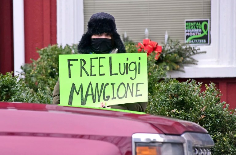 An unidentified woman protests for the release of Luigi Nicholas Mangione at the Blair County Courthouse in Hollidaysburg, Pennsylvania, Thursday, Dec. 19, 2024.