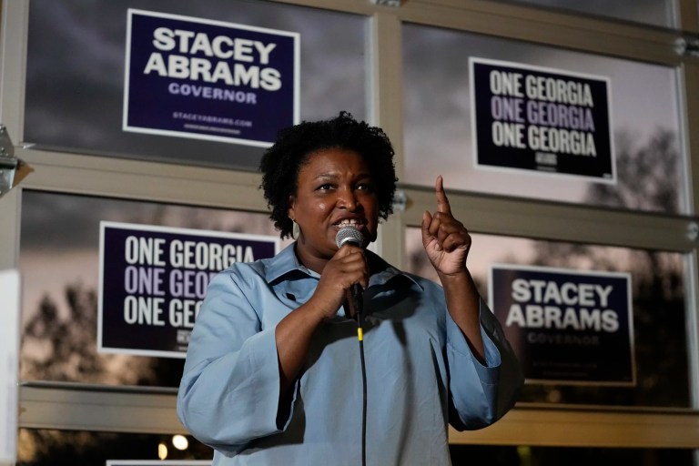 Stacey Abrams, Democratic candidate for Georgia governor, speaks to volunteers during an election eve phone and text bank party, Nov. 7, 2022, in Atlanta.