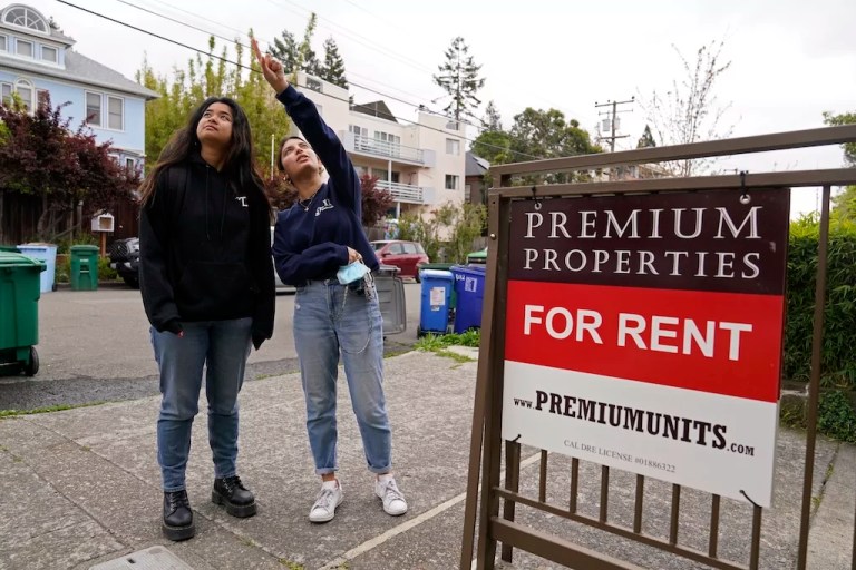 Two college students look for an apartment to rent.