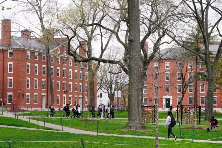 Students walk through Harvard Yard, on the campus of Harvard University in Cambridge, Massachusetts.