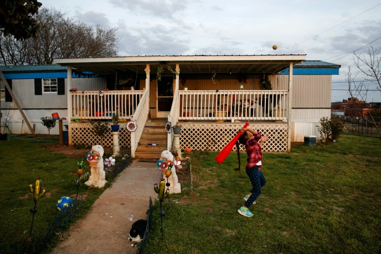 Dulce, 6, plays in the yard of their family home across the railroad tracks in Burlington, North Carolina, Monday, March 9, 2020.