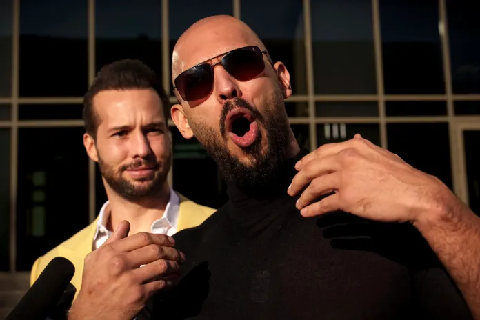 Andrew Tate gestures, next to his brother, Tristan, outside the Bucharest Tribunal in Bucharest, Romania, Thursday, Jan. 9, 2025.