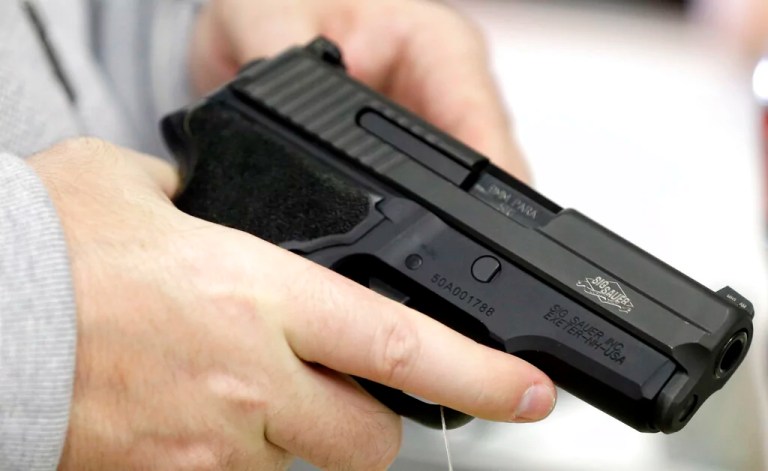 David Foley holds a handgun while shopping at the Spring Guns and Ammo store Monday, Jan. 4, 2016, in Spring, Texas.