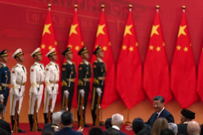 Chinese President Xi Jinping, right, invites winners of the national medals to join him after a ceremony held in the Great Hall of the People in Beijing, Sunday, Sept. 29, 2024.