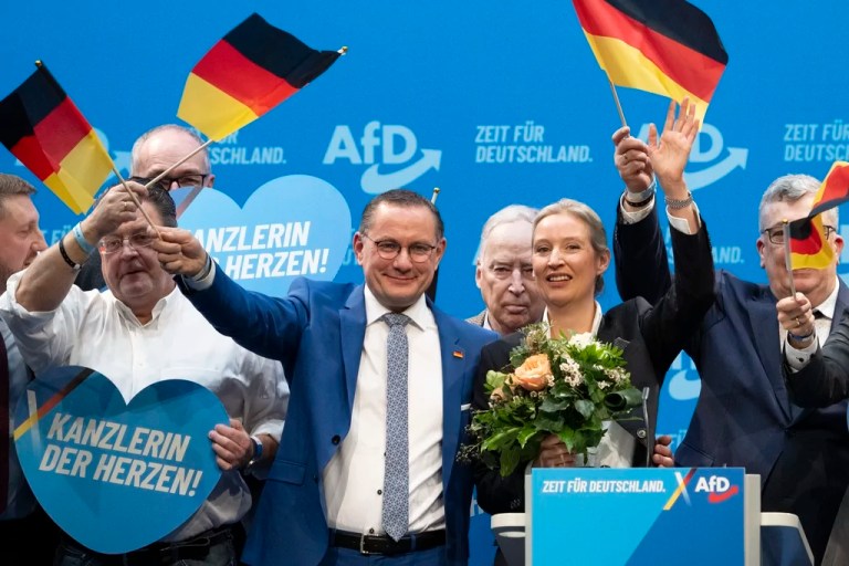 Tino Chrupalla, foreground center, Alternative for Germany national chairman and parliamentary group leader of the AfD, and Alice Weidel, AfD national chairwoman, stand on stage at the AfD national party conference following Weidel's nomination as candidate for chancellor in the upcoming federal elections, in Riesa, Germany, Saturday, Jan. 11, 2025.