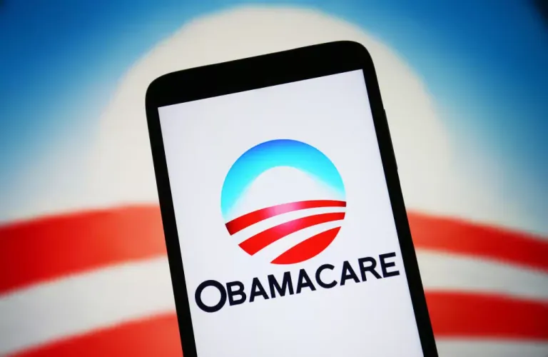 A phone with the Obamacare logo on the screen.