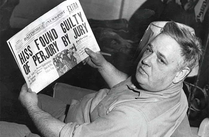 Whittaker Chambers reads the headline documenting the conviction of Alger Hiss.