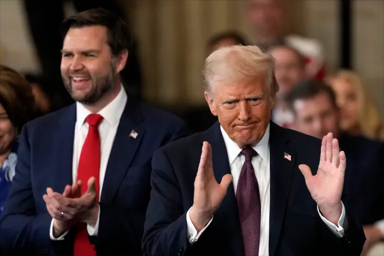 President Donald Trump gestures as Vice President JD Vance applauds during the 60th presidential inauguration, Monday, Jan. 20, 2025, in the Capitol Rotunda in Washington.